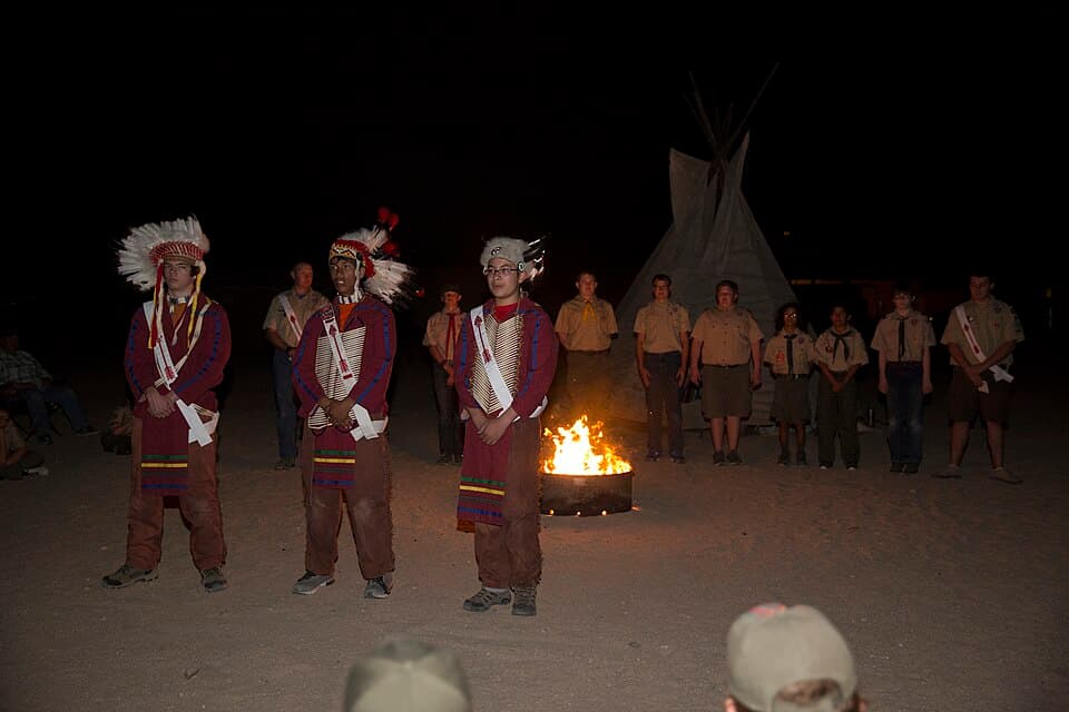 Scouts standing during an Order of the Arrow ceremony